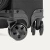 Close-up of suitcase wheels on a white background