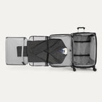 Open suitcase with suit displayed in fold out suiter compartment on white background