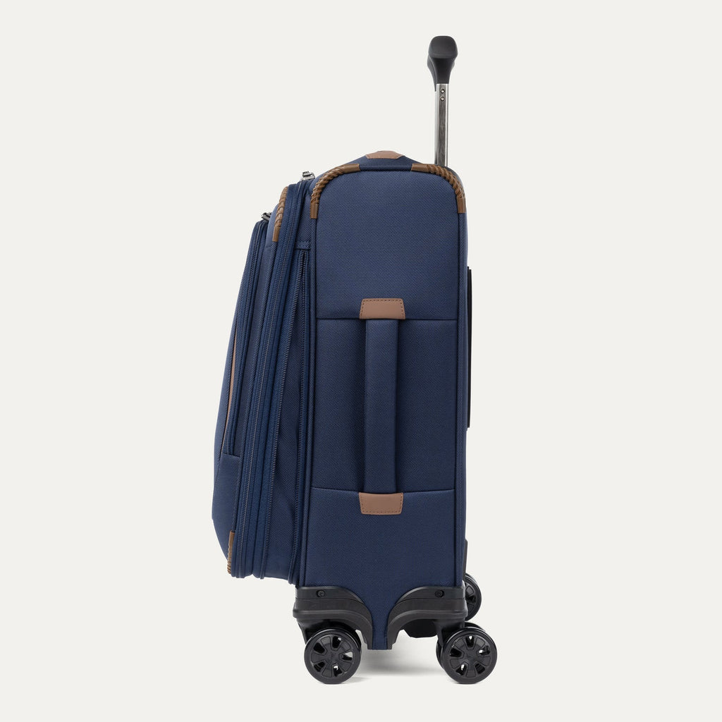 Side view of expanded blue suitcase with extended handle on a white background
