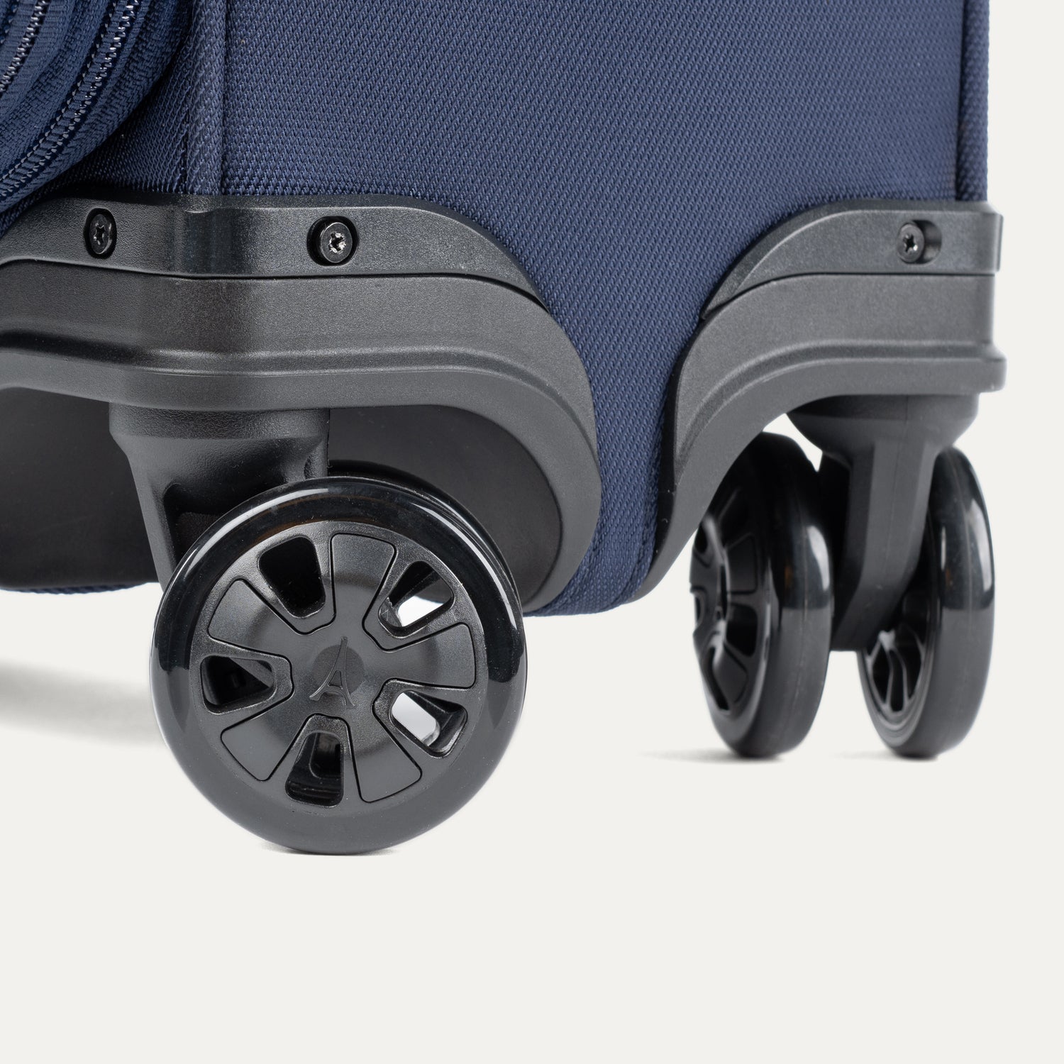 Close-up of suitcase wheels on a white background