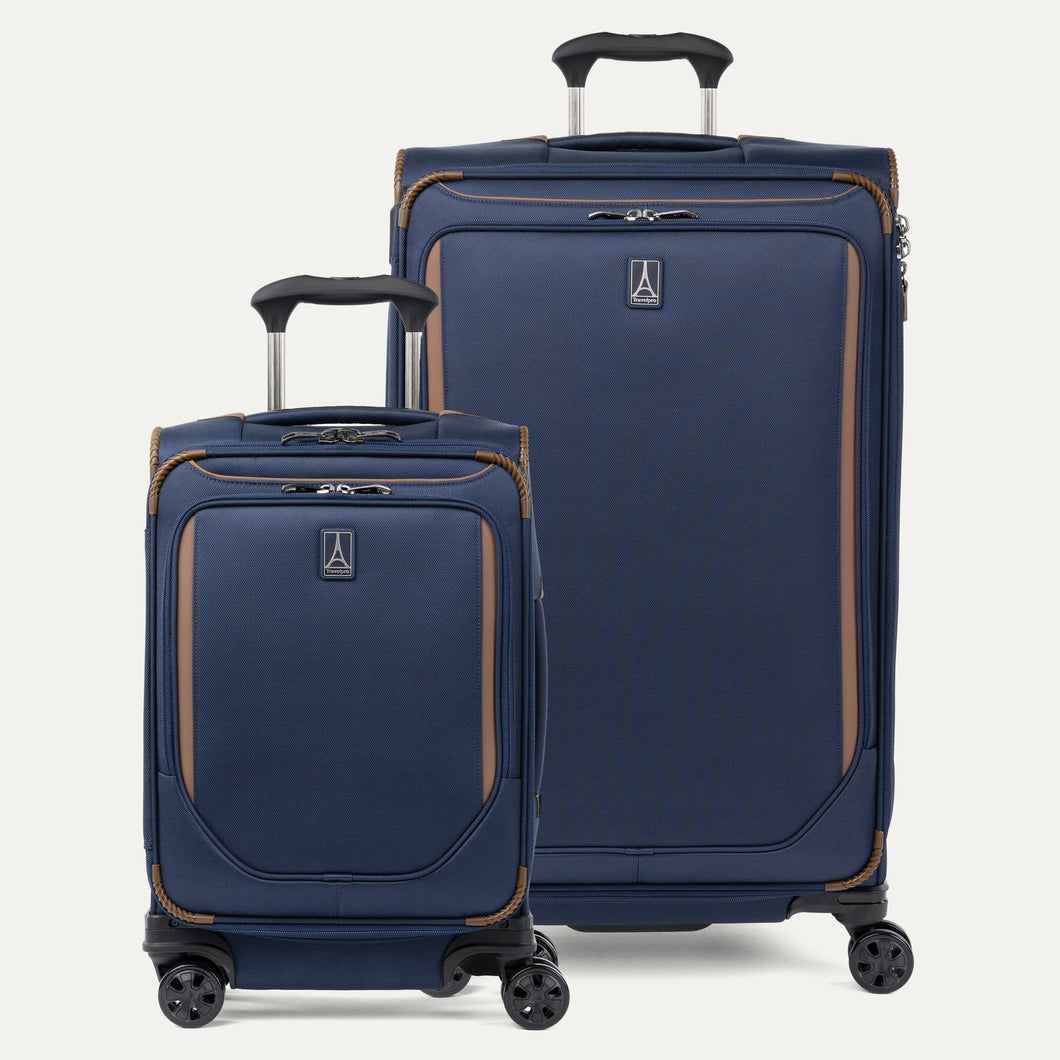 A set of two blue spinner suitcases, one carry-on size and one check-in size, with brown accents on a white background 