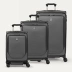 A set of three gray spinner suitcases, including a carry-on size, medium size, and large size, aligned in a row with the telescopic handles extended.