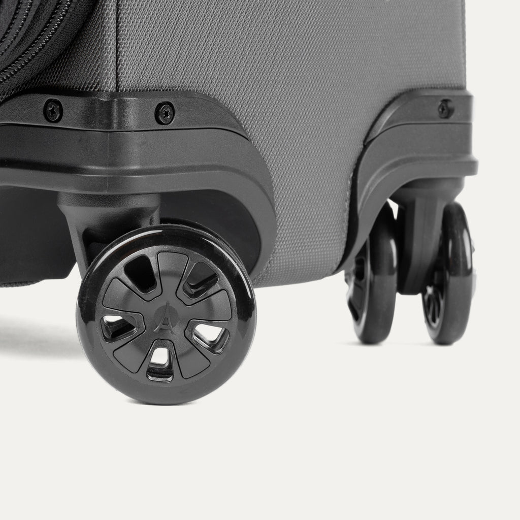 Close-up of a black suitcase with black wheels on a white background