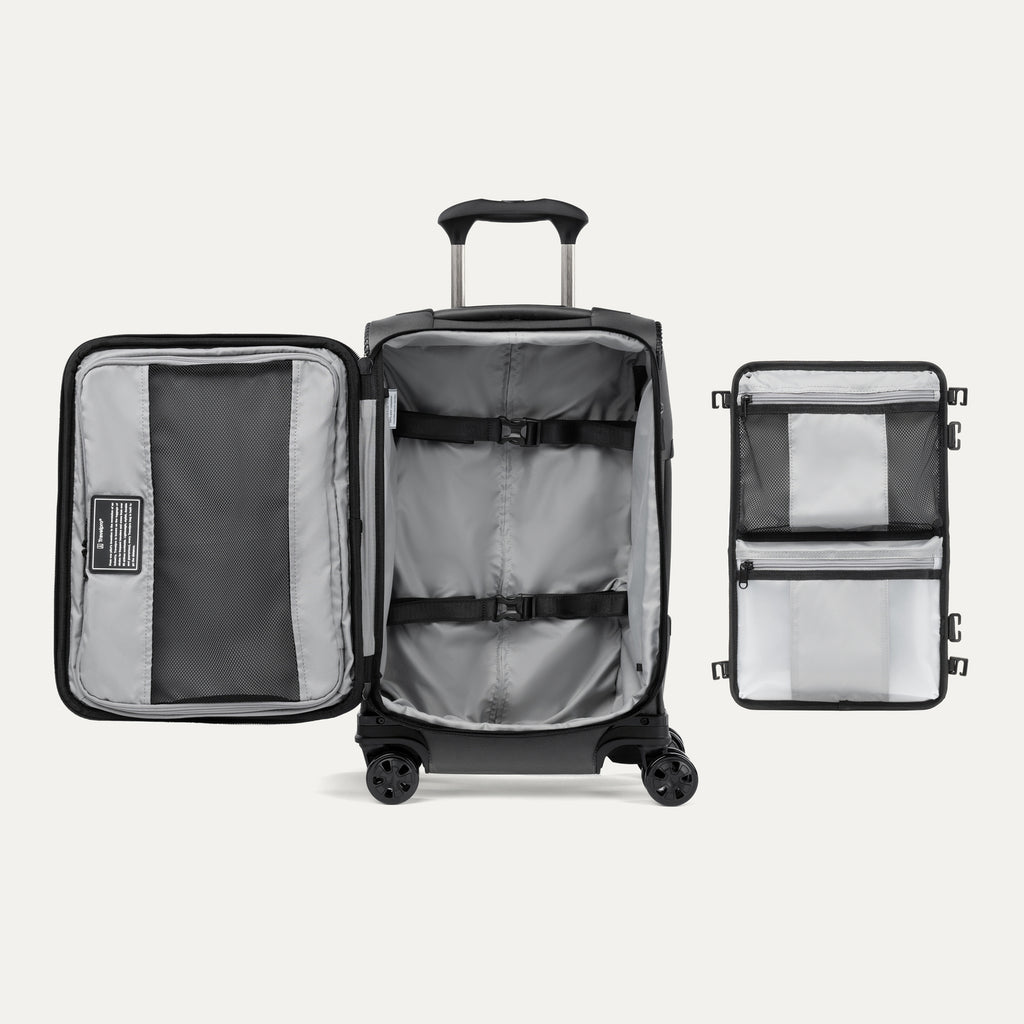 Open black suitcase featuring packing organizer on a white background.