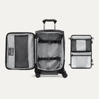 Open black suitcase featuring packing organizer on a white background.