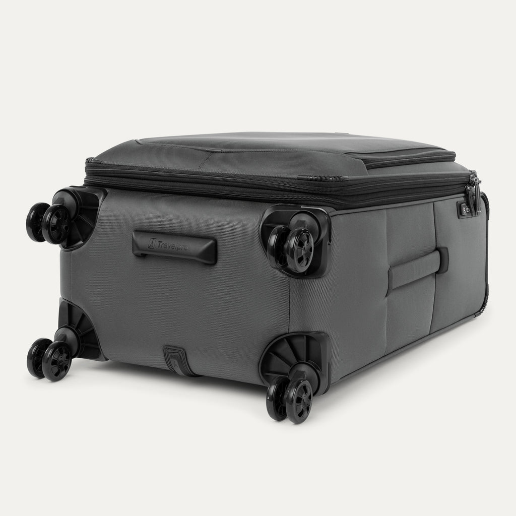 Grey suitcase with black wheels on a white background