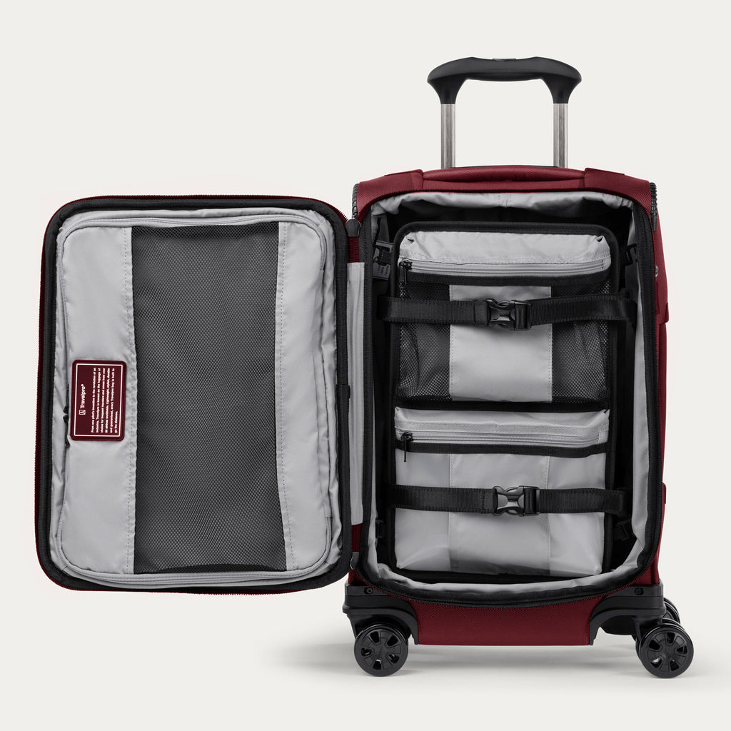 Interior view of the Crew™ Classic Carry-on Spinner in Rosewood Red, showcasing built-in accessory compartments and compression straps for organized packing.
