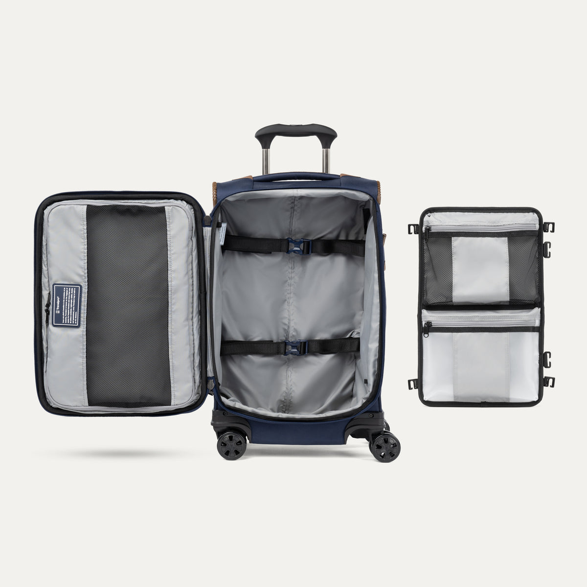 Interior view of the Crew Classic Carry-On Spinner in Patriot Blue, showing the lightweight softside design, PowerScope Lite telescoping handle, protective corner guards, and multi-directional spinner wheels against a clean off-white background.