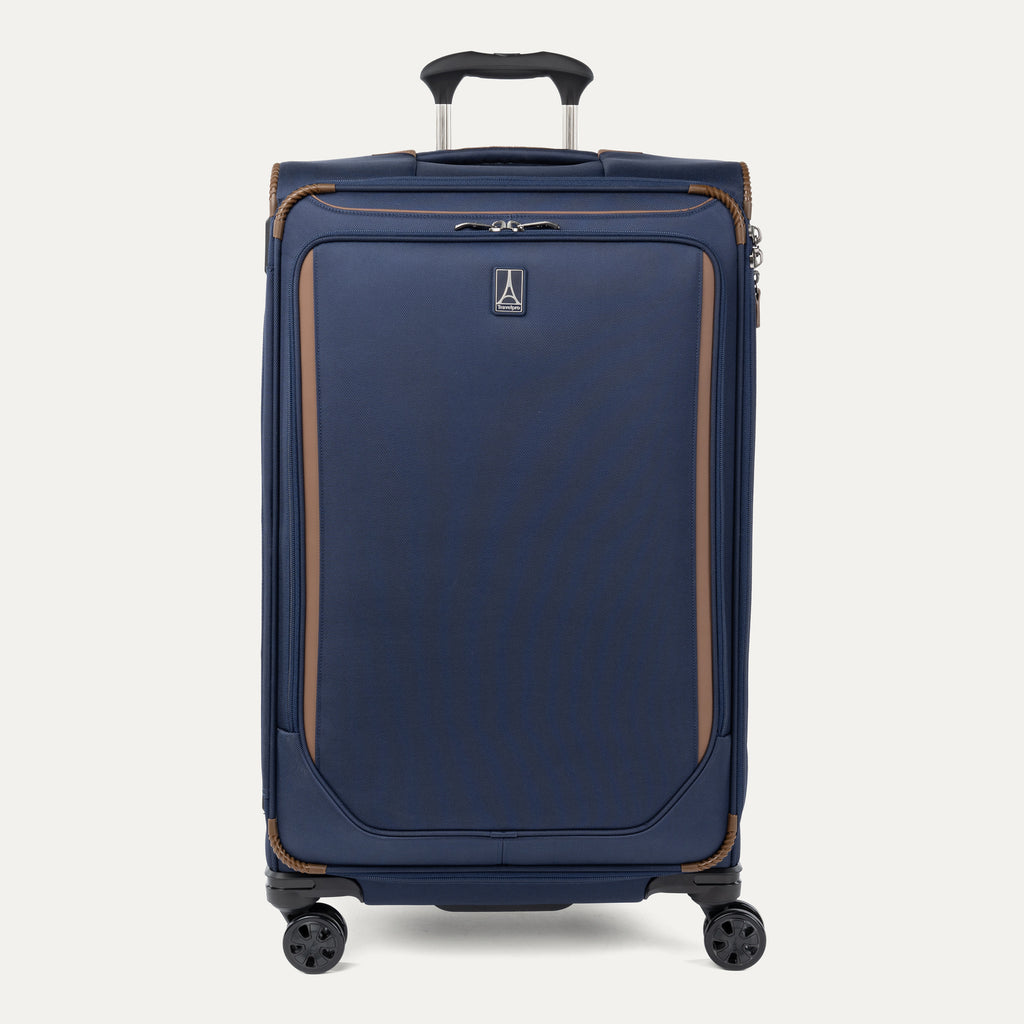 Front view of Travelpro Crew Classic Large Check-In Expandable Spinner in Patriot Blue, with 360° Spinner Wheels, corner reinforcements, and low-profile top carry handle.
