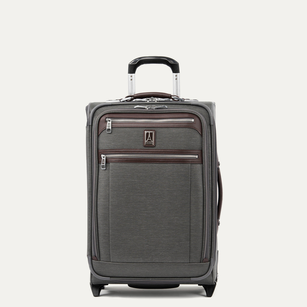 Front view of Travelpro Platinum Elite Carry-On Rollaboard in Vintage Grey, showing dual zippered front pockets, leather trim, side carry handle, and telescoping handle.