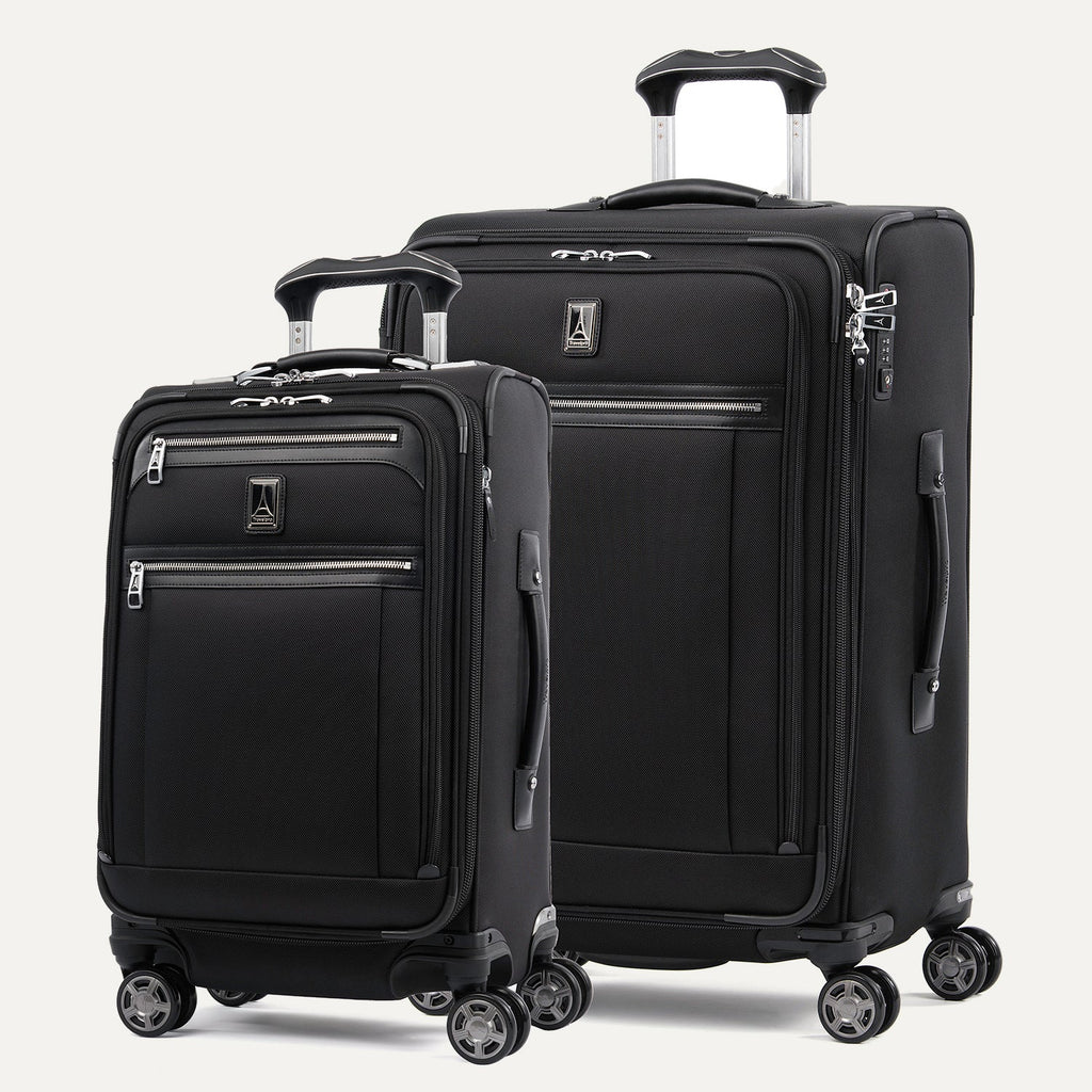 A set of two black Platinum Elite spinner suitcases, one carry-on size and one medium check-in size, with chrome zippers and TSA locks.