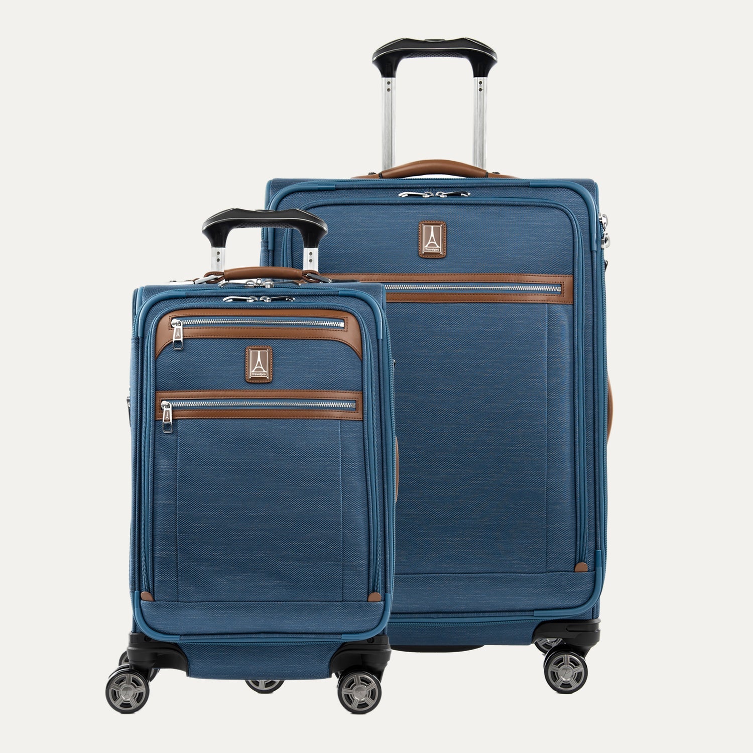 A set of two blue Platinum Elite spinner suitcases, one carry-on and one medium check-in size, with brown leather accents and chrome zippers.