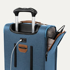 Blue suitcase with USB cable and other accessories visible on a white background 