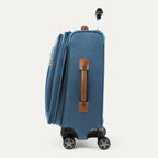 Side view of expanded blue suitcase with brown side handle on a white background