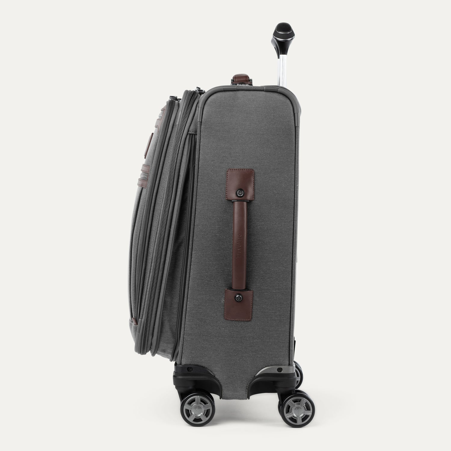 Side view of expanded gray suitcase with brown side handle on a white background