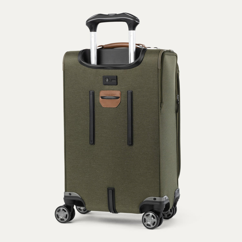 Green suitcase with handle and wheels on a white background