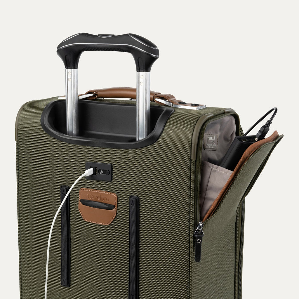 Green suitcase with USB cable and other accessories visible on a white background