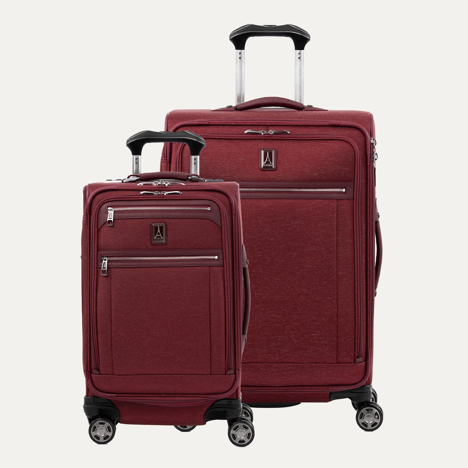 Two red suitcases with wheels and extended handle on a white background