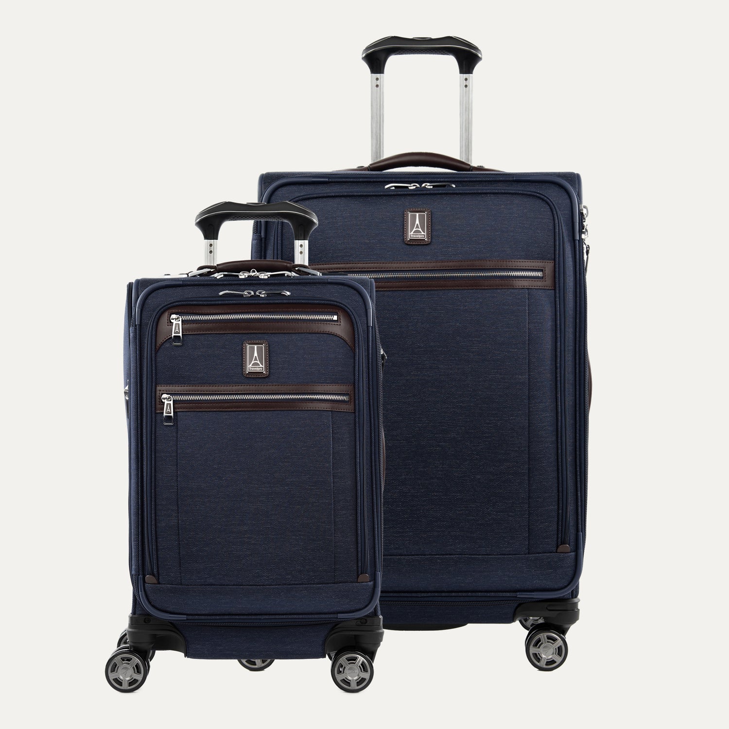 Two blue suitcases with wheels and extended handle on a white background