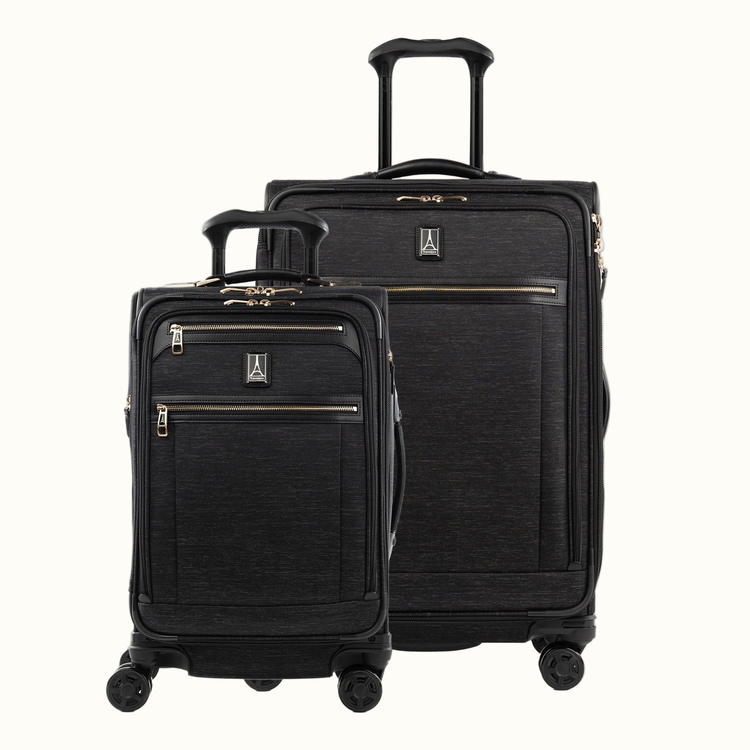 A set of two black Platinum Elite spinners, one carry-on and one medium check-in size, with chrome zippers and a leather accent on the front pocket.