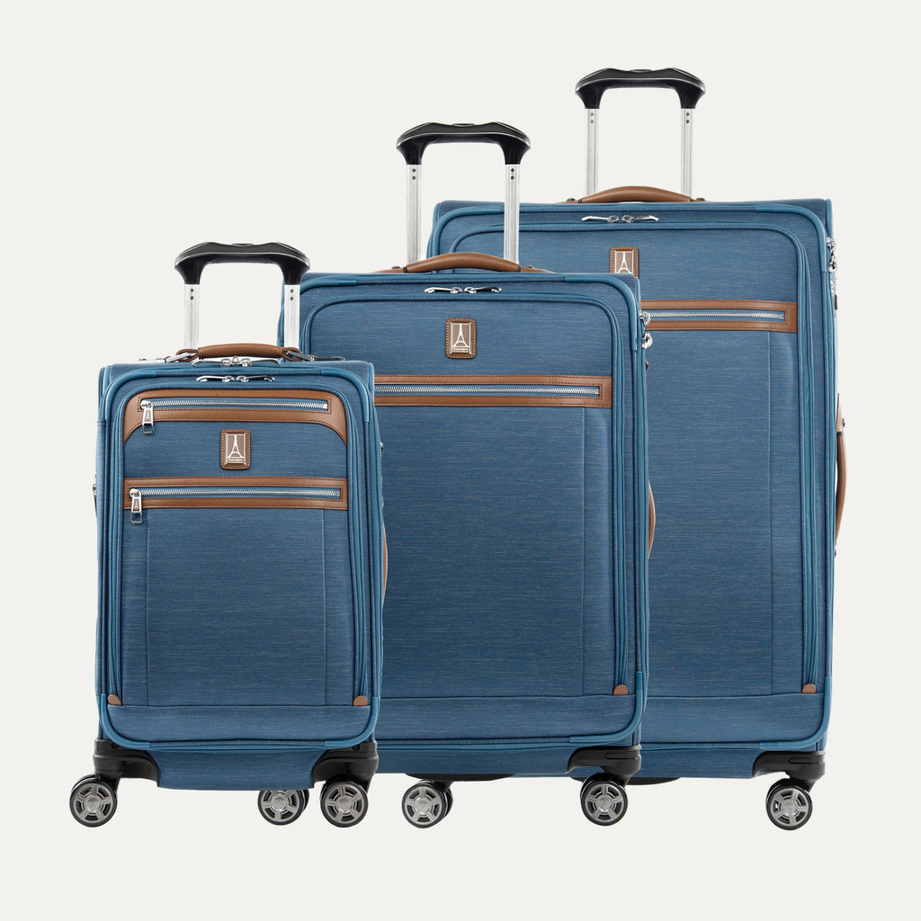 Set of three blue suitcases with brown accents on a white background