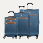 Set of three blue suitcases with brown accents on a white background