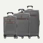 A set of three grey Platinum Elite spinner luggage bags, including a carry-on size and two larger sizes, with chrome zippers and leather accents.
