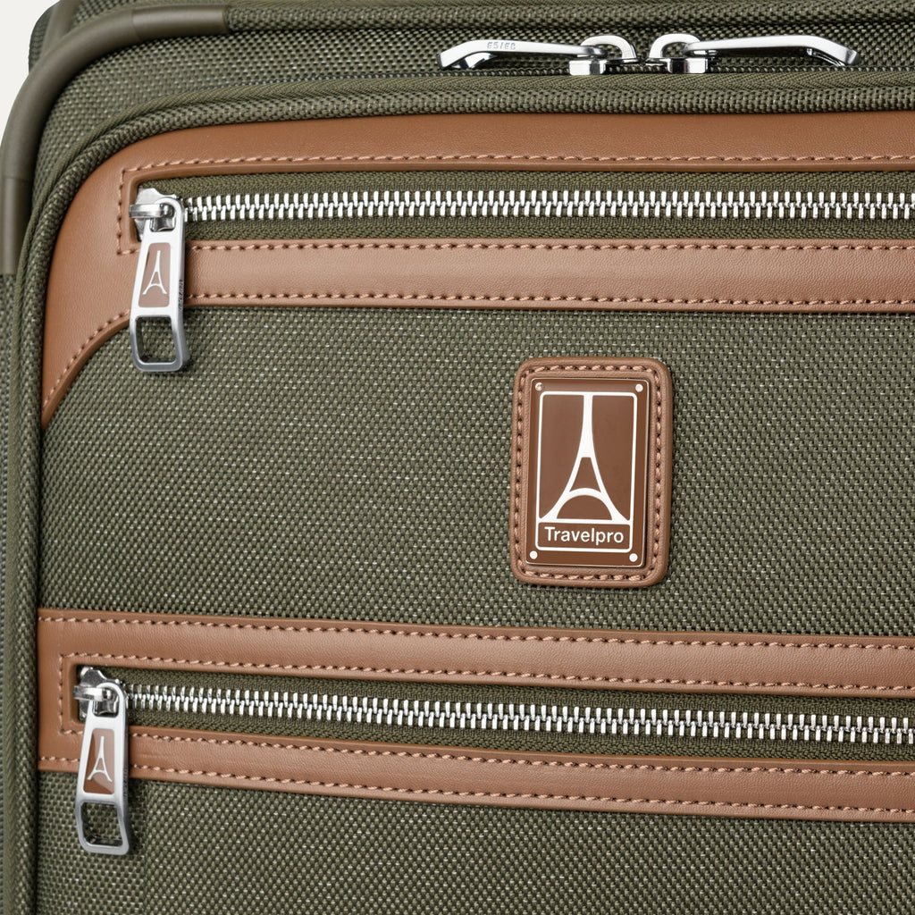 Close-up of a green suitcase with zippers and travelpro logo.