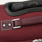 Close-up of a red suitcase handle and lock mechanism.