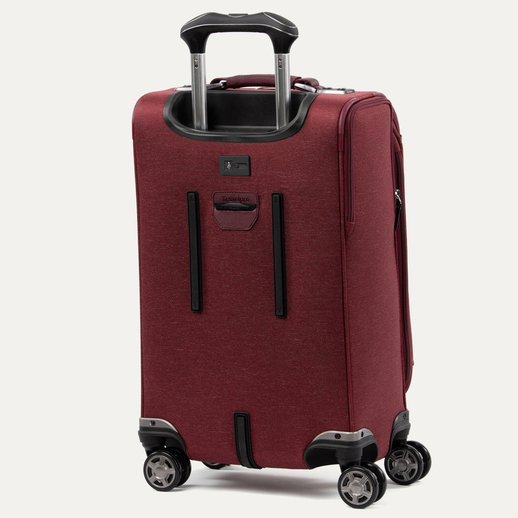 Red suitcase with wheels on a white background