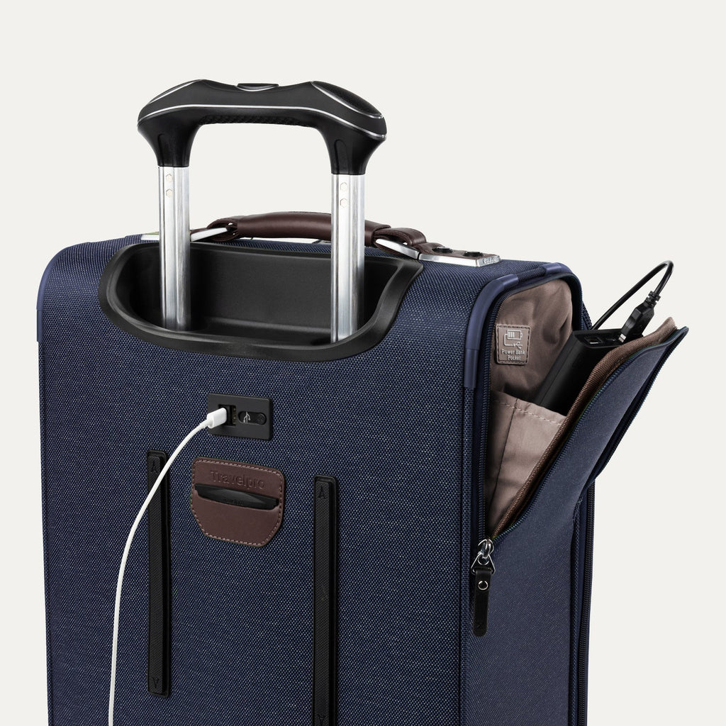 Blue suitcase with USB cable and other accessories visible on a white background