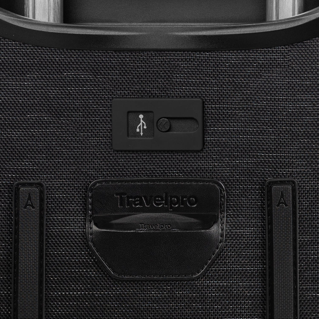 Close-up of a black suitcase with USB port and Travelpro branding.
