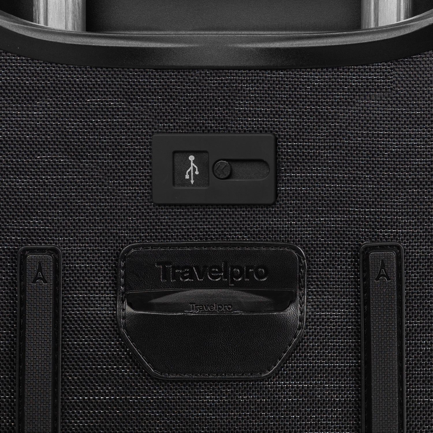 Close-up of a black suitcase with USB port and Travelpro branding.