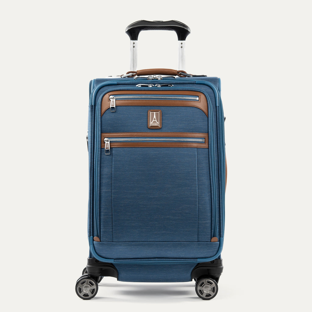 Front view of Travelpro Platinum Elite Carry-On Spinner in Coastal Blue, with dual front zippered pockets, leather trim, spinner wheels, and telescoping handle.
