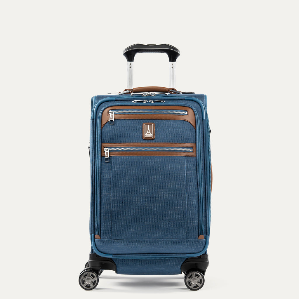 Front view of Travelpro Platinum Elite Carry-On Spinner in Coastal Blue, with dual front zippered pockets, leather trim, spinner wheels, and telescoping handle.