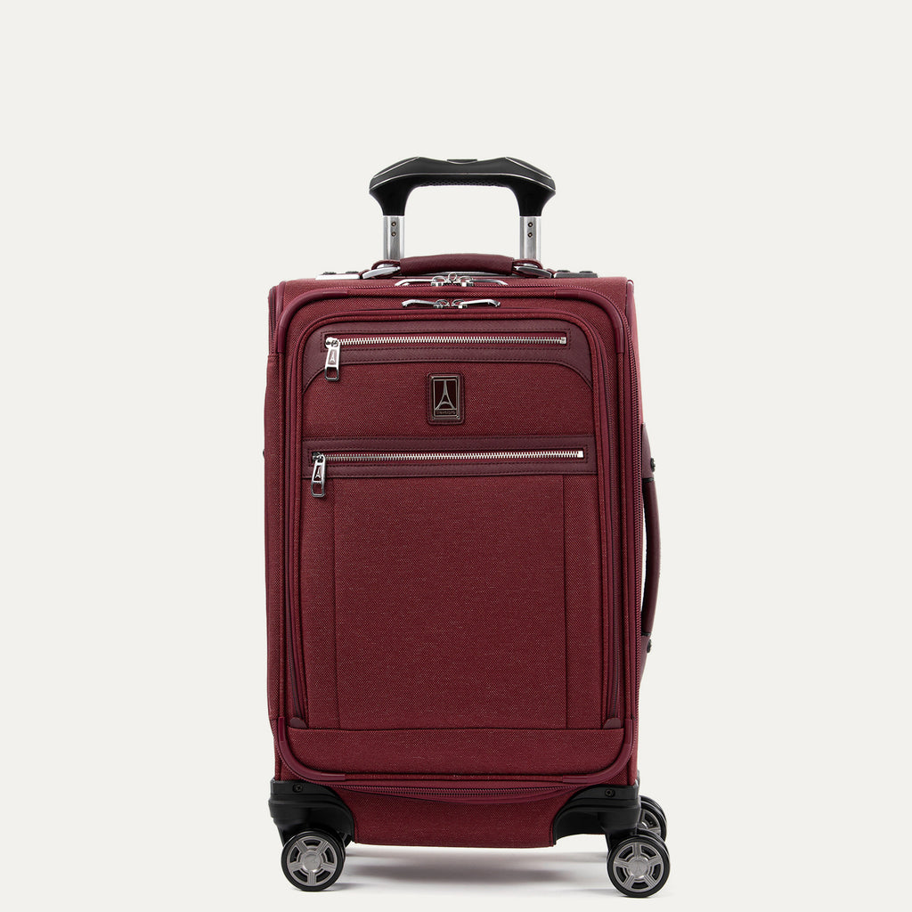 Front view of Travelpro Platinum Elite Carry-On Spinner in Bordeaux, with dual exterior zippered pockets and PowerScope Extension Handle.
