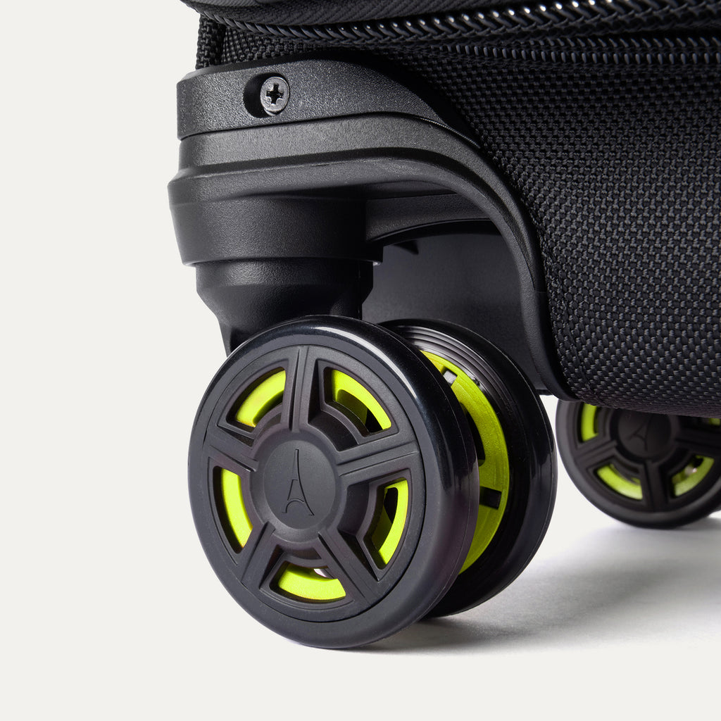Detailed close-up of the spinner wheels on the Platinum Elite Neon Shadow Carry-On in black, highlighting the durable wheel construction and the signature neon green accents on the center wheel caps.