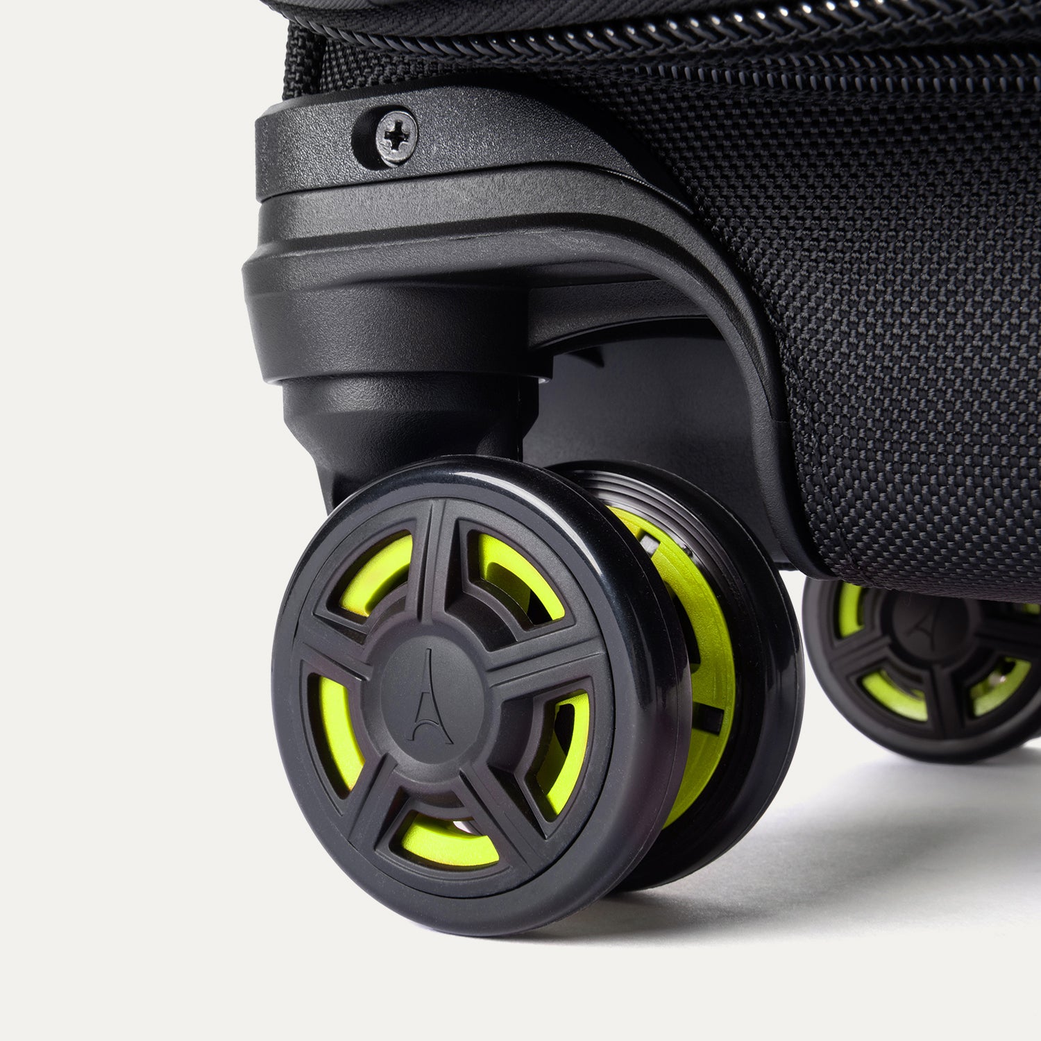 Detailed close-up of the spinner wheels on the Platinum Elite Neon Shadow Carry-On in black, highlighting the durable wheel construction and the signature neon green accents on the center wheel caps.
