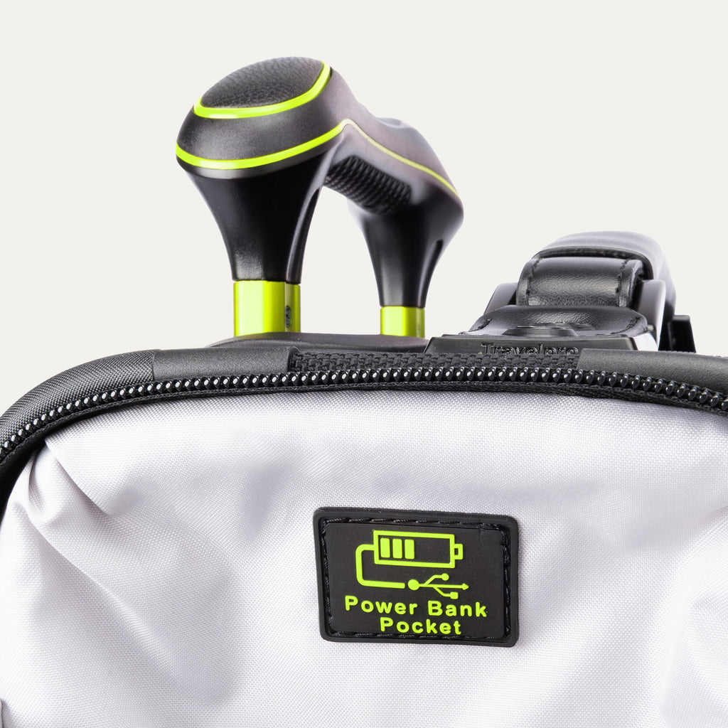 Close-up of the 'Power Bank Pocket' feature on the Platinum Elite Neon Shadow Carry-On in black, highlighting the dedicated zippered pocket with a battery icon and the ergonomic top handle with neon green accents.