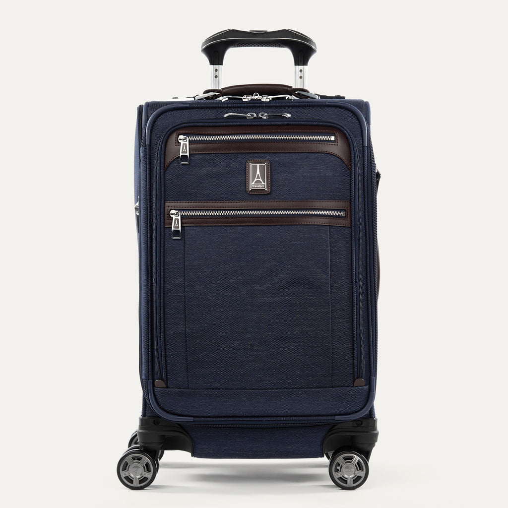 Front view of Travelpro Platinum Elite International Carry-On Spinner in True Navy, with leather-accented zippered pockets and PowerScope Extension Handle.
