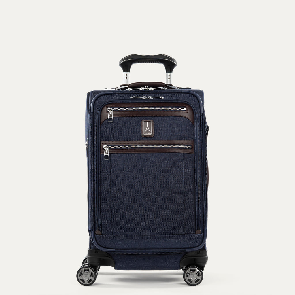 Front view of Travelpro Platinum Elite International Carry-On Spinner in True Navy, with leather-accented zippered pockets and PowerScope Extension Handle.
