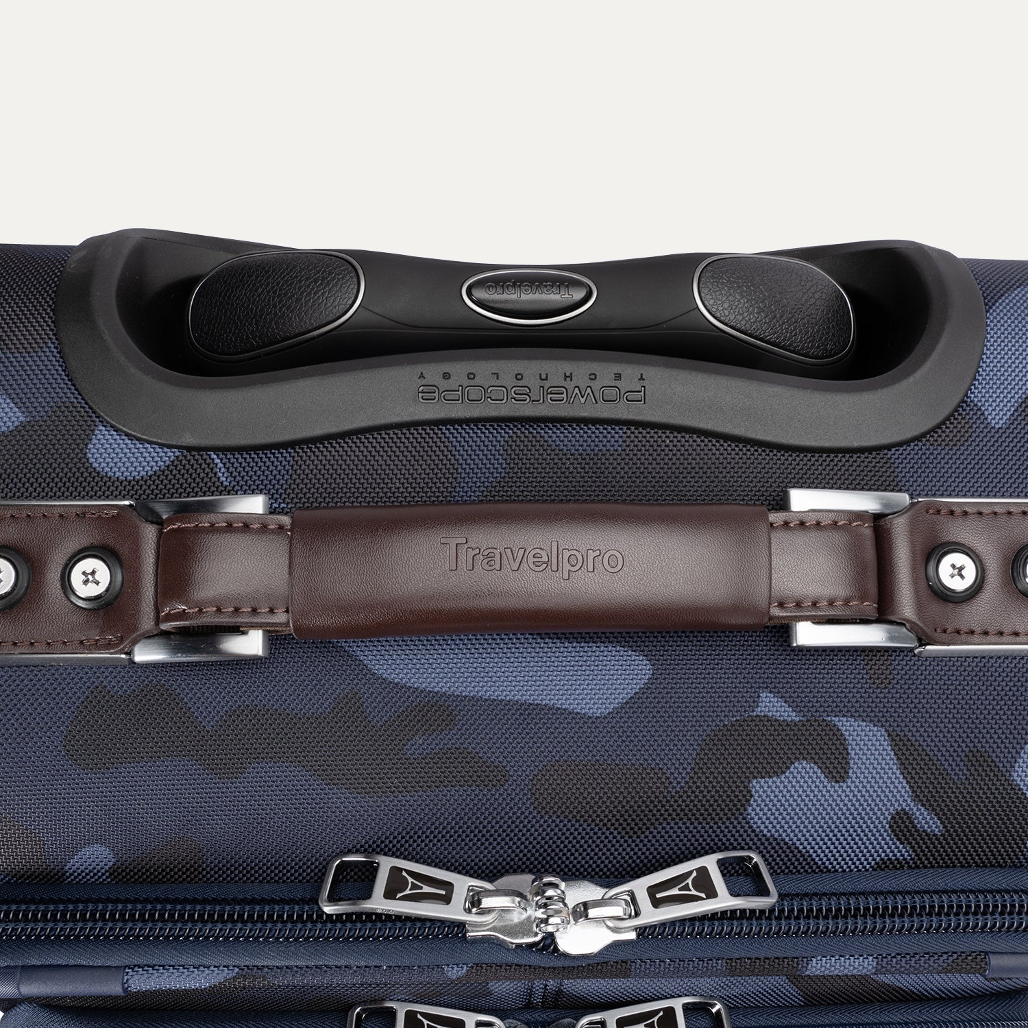 Close-up of Platinum® Elite Carry-On Spinner in Camouflage, highlighting the leather-wrapped top handle, Powerscope handle system, and top zipper section.