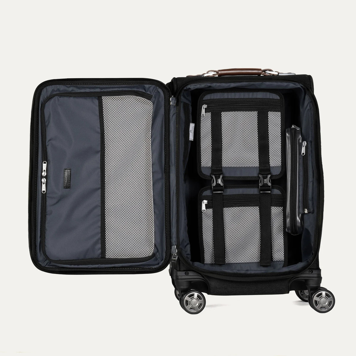Interior detail view of the Travelpro Platinum Elite Carry-On Spinner in black, featuring the spacious packing compartment with zippered mesh dividers and adjustable compression straps for organized travel.
