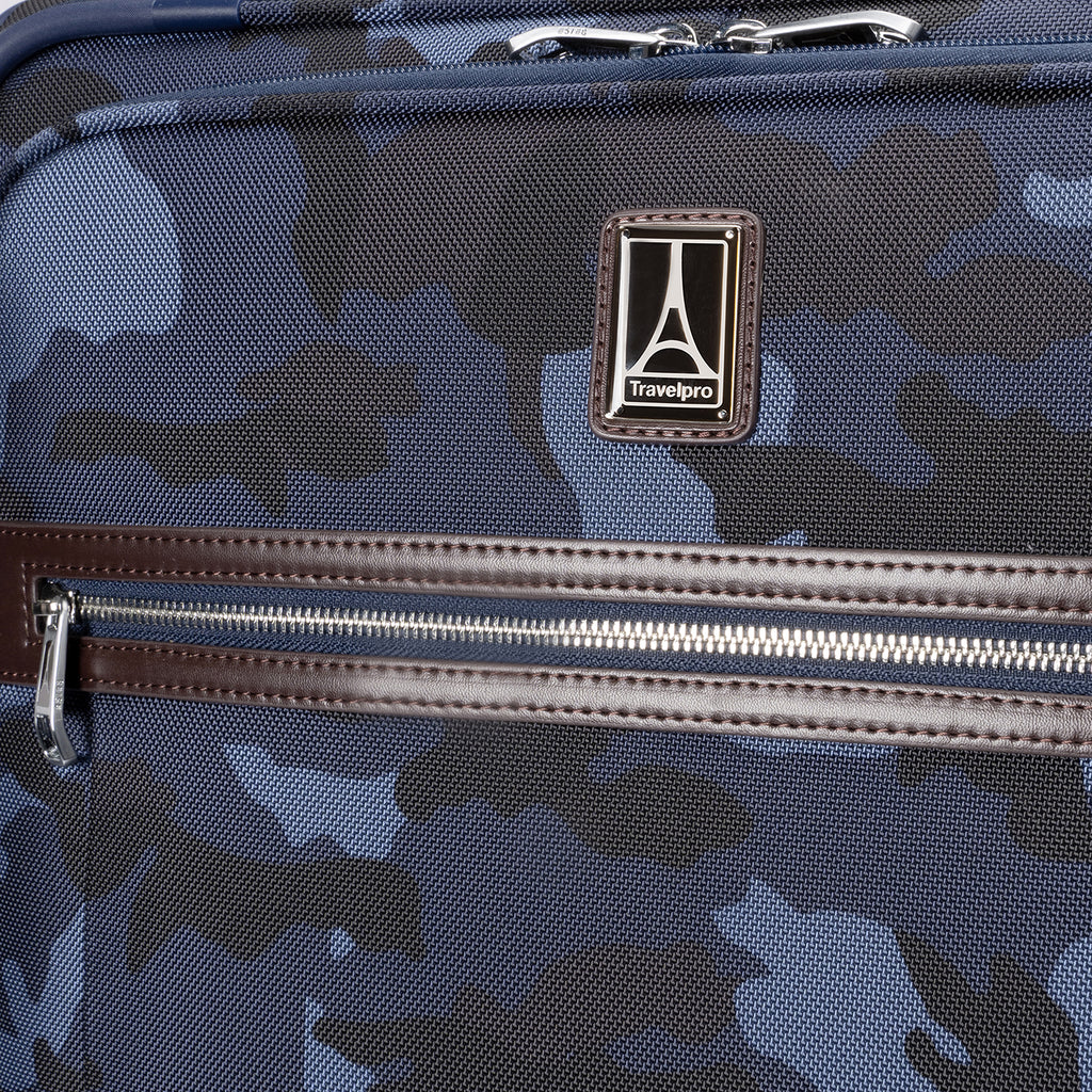 Travelpro logo and front zippered pocket with leather trim on Platinum® Elite Medium Check-In Spinner in Camouflage.
