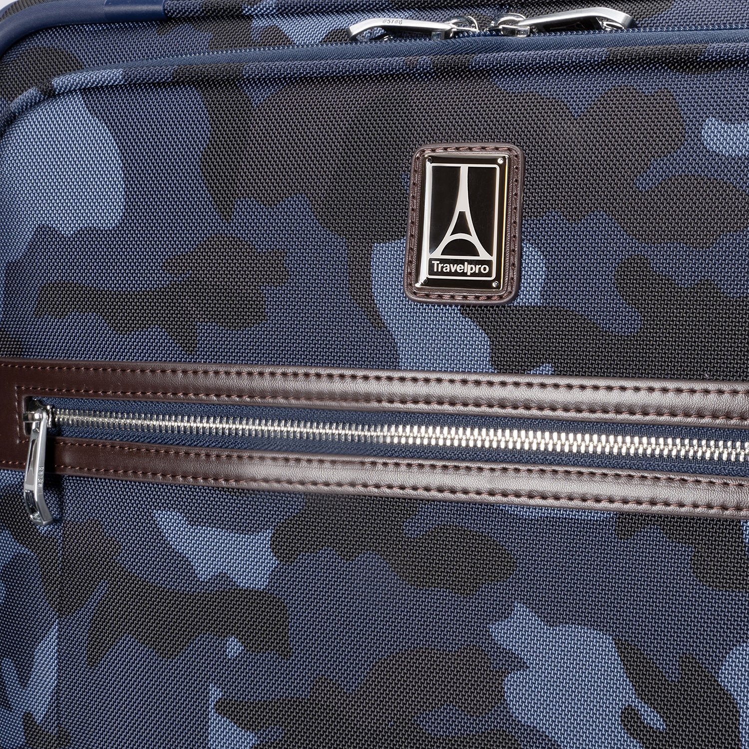 Travelpro logo and front zippered pocket with leather trim on Platinum® Elite Medium Check-In Spinner in Camouflage.
