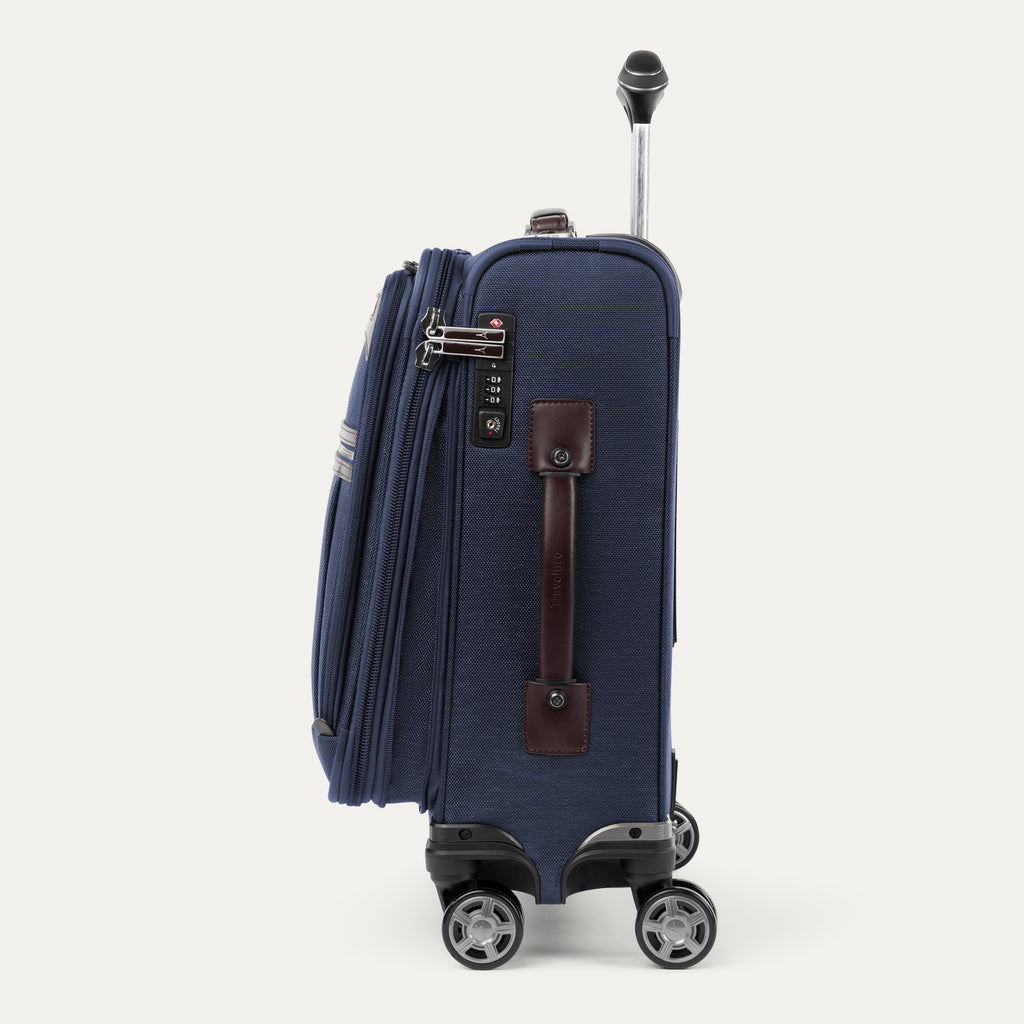 Side view of the Travelpro® Platinum® Elite International Carry-On Spinner in True Navy, featuring a built-in TSA-approved lock, leather side handle, and 360° spinner wheels.
