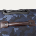 Close-up of top and leather carry handle on the Platinum® Elite Large Check-In Spinner in Camouflage.