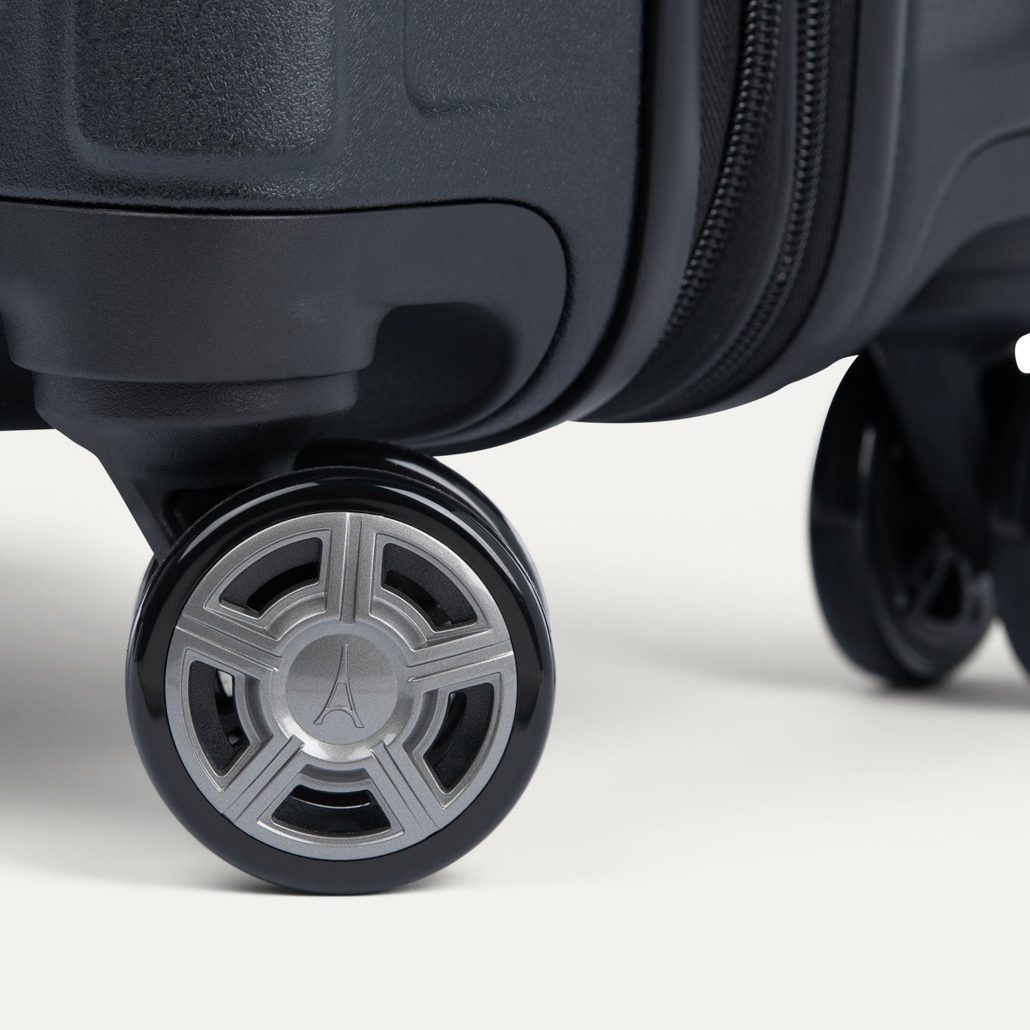 Close-up of suitcase wheels on a white background