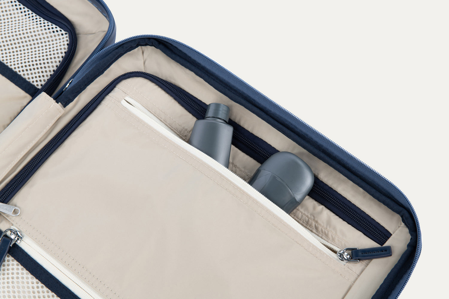 Close-up of a open suitcase interior with toiletries inside.