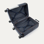 Open navy suitcase with black wheels on a light background